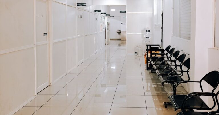 Modern hospital corridor with empty waiting chairs, where in-hospital shortfalls arise